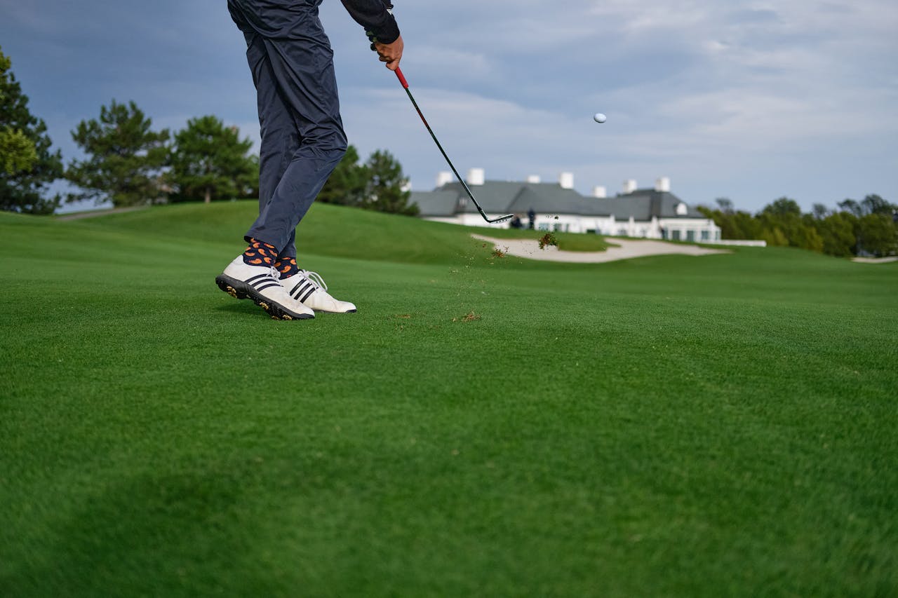 Services-01 A golfer mid-swing on a beautiful green golf course in Oberwaltersdorf, Austria.